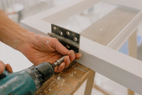 screwing nails into a bracket